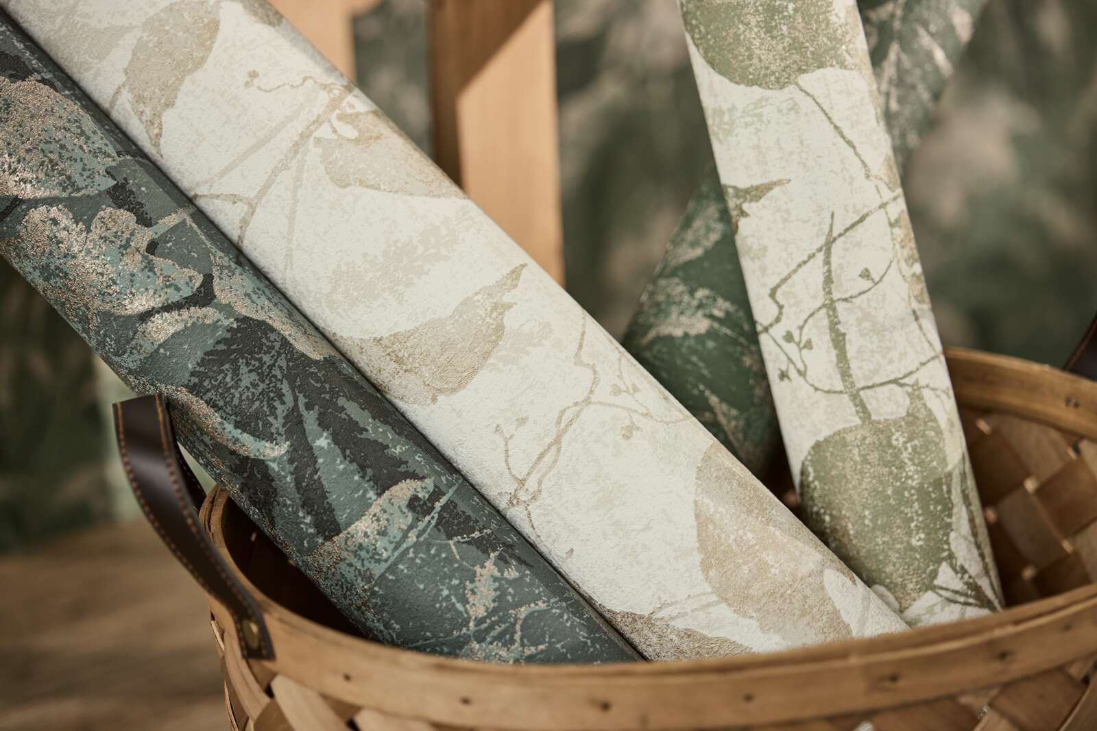 Zaļas un zelta tapetes ar košu lapu dizainu un teksturētu virsmu - viesistabas interjerā