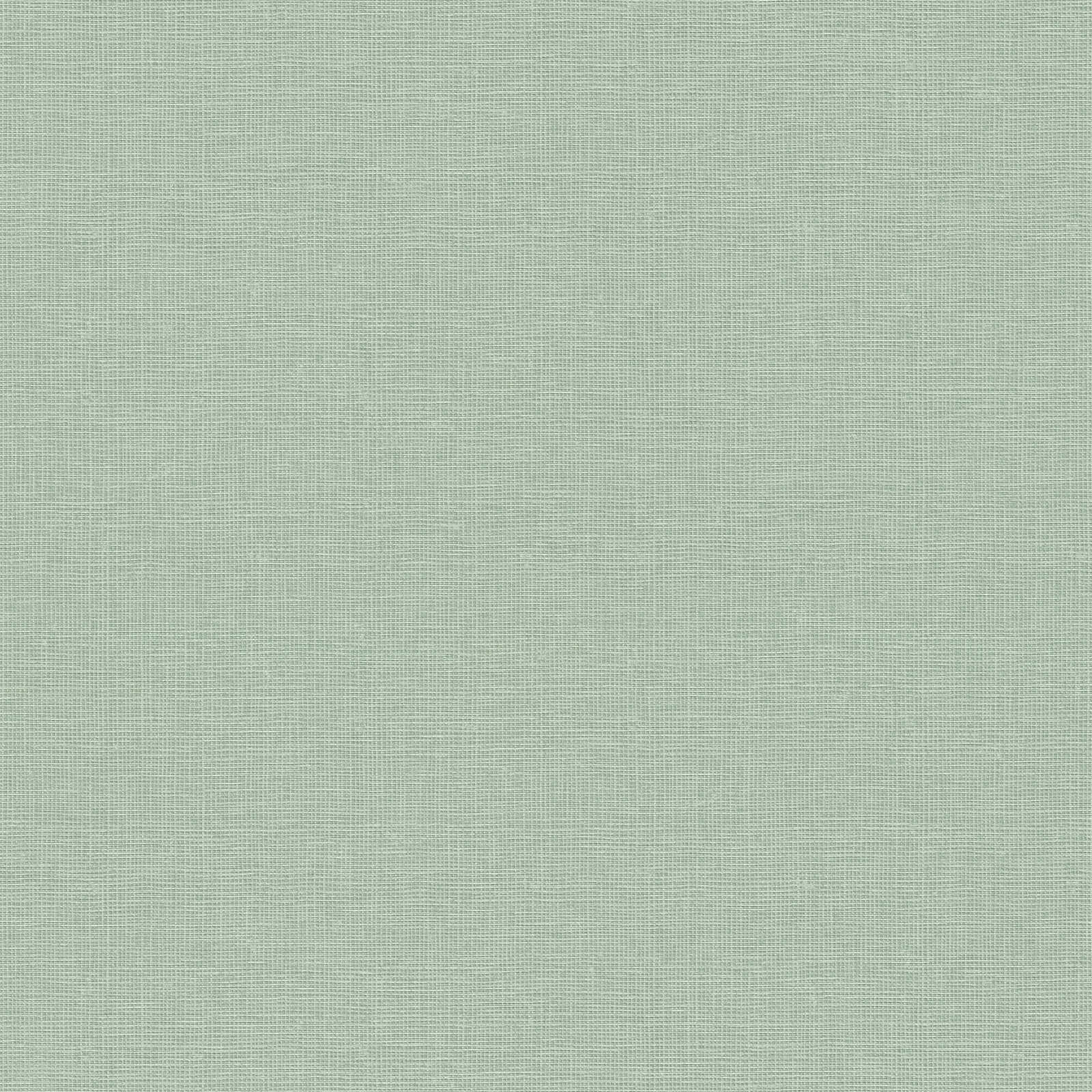 Zaļas flizelīna tapetes ar dabīgās lina tekstūras efektu - guļamistabas interjerā